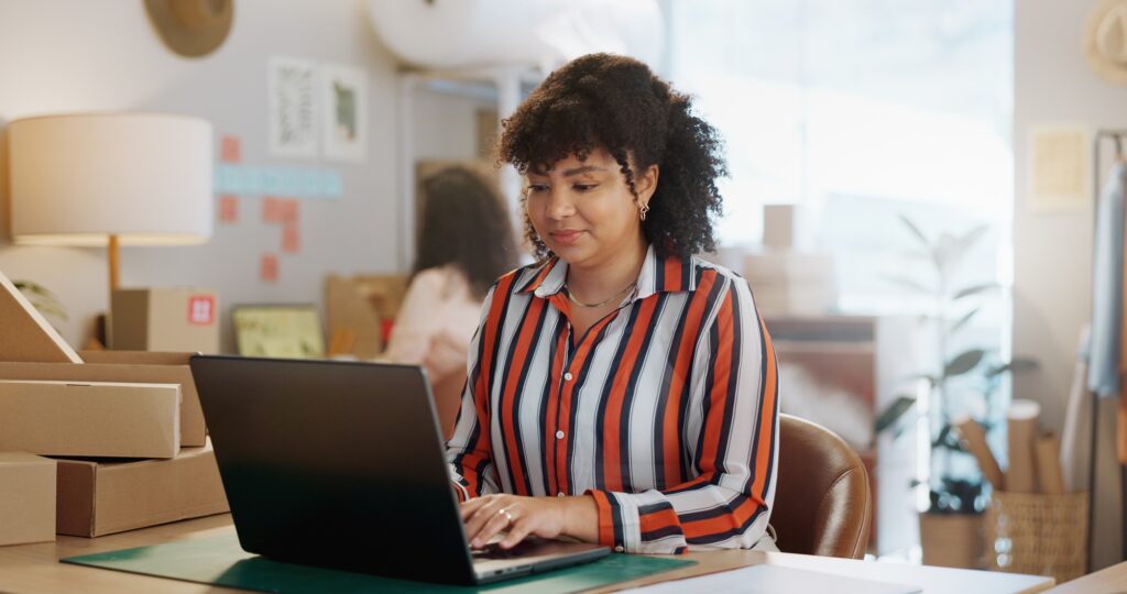 Small business, research and happy woman with laptop in office for logistics, sales or ecommerce. S